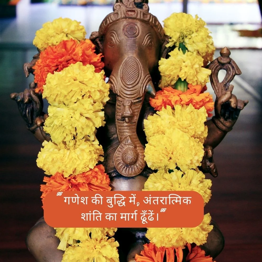 wooden brown ganesh ji stachu is displayed, the ganesh ji stachu wearing the big yellow garland real flower, spiritual quote also placed