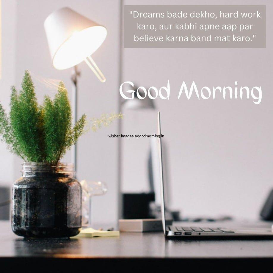 Sideways Desk is visible, white background and lamp of white is visible, plant also placed, good morning quote