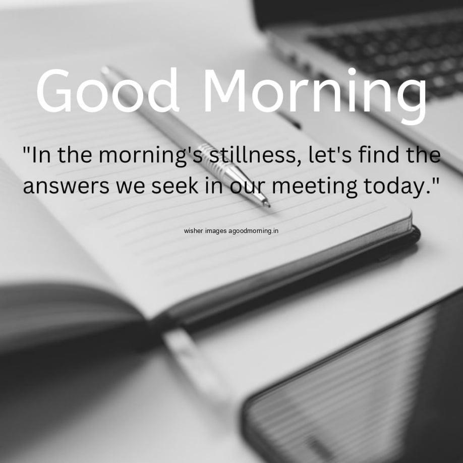 Notebook, pen, mobile are placed on table, good morning quote