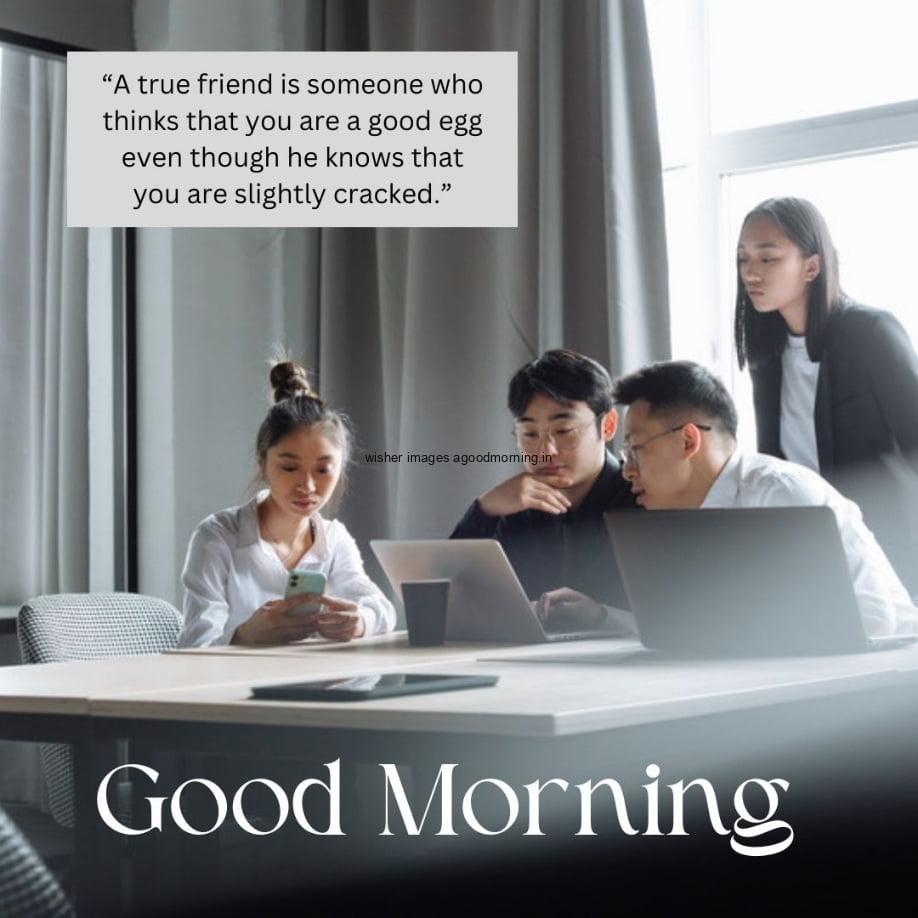 Team is working and see the laptop screen, mostly thinks is grey, good morning quote is placed