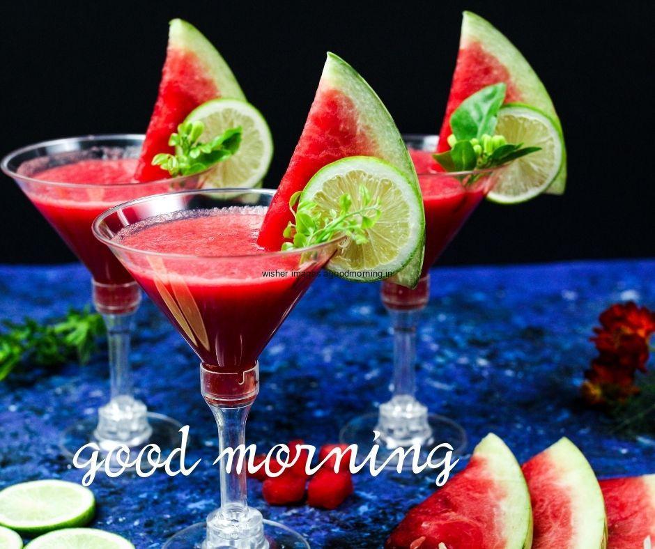 Black-background-with-blue-base-watermelon-with-three-juice-glasses-white-good-morning-text-good-morning-image HD Good Morning Images with juices Free