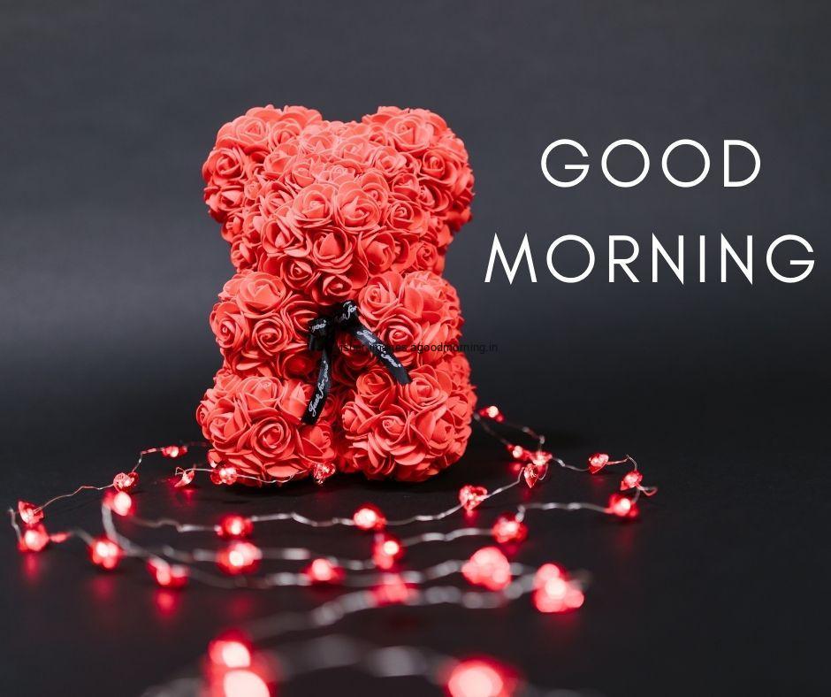 Black background with red hearts, red teddy, good morning quote is placed