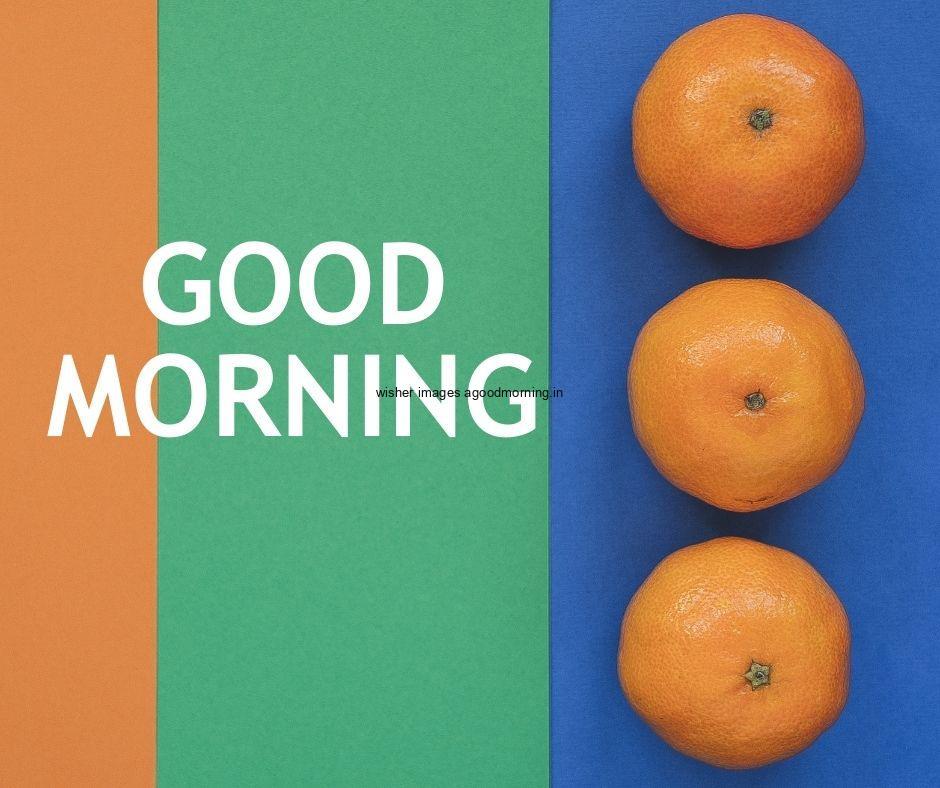 Blue, yellow, green background with three oranges with good morning image text colour white