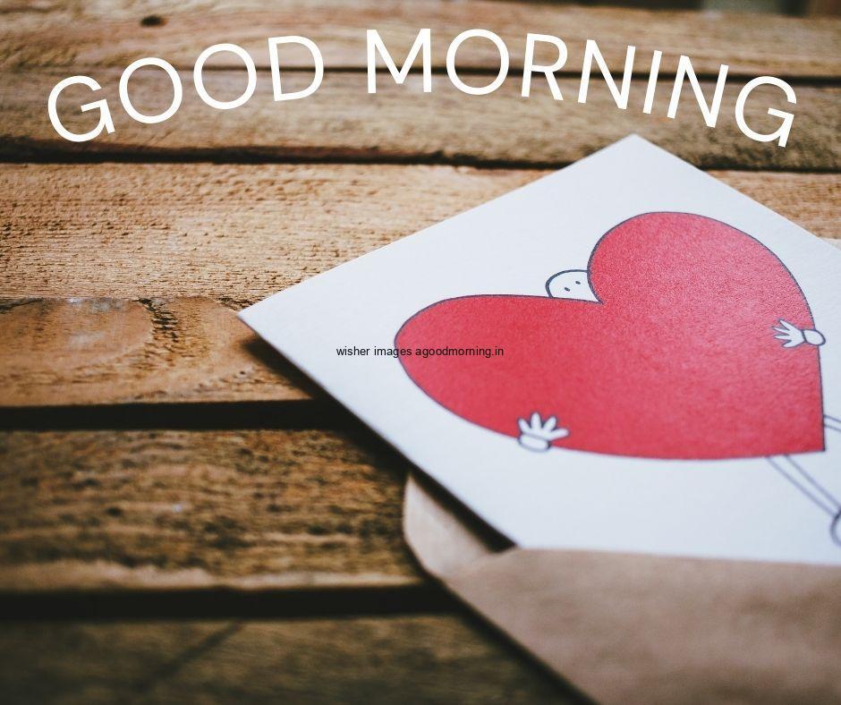 Brown wooden background letter opend and letter goes out side and red heart printed on paper good morning love images free download