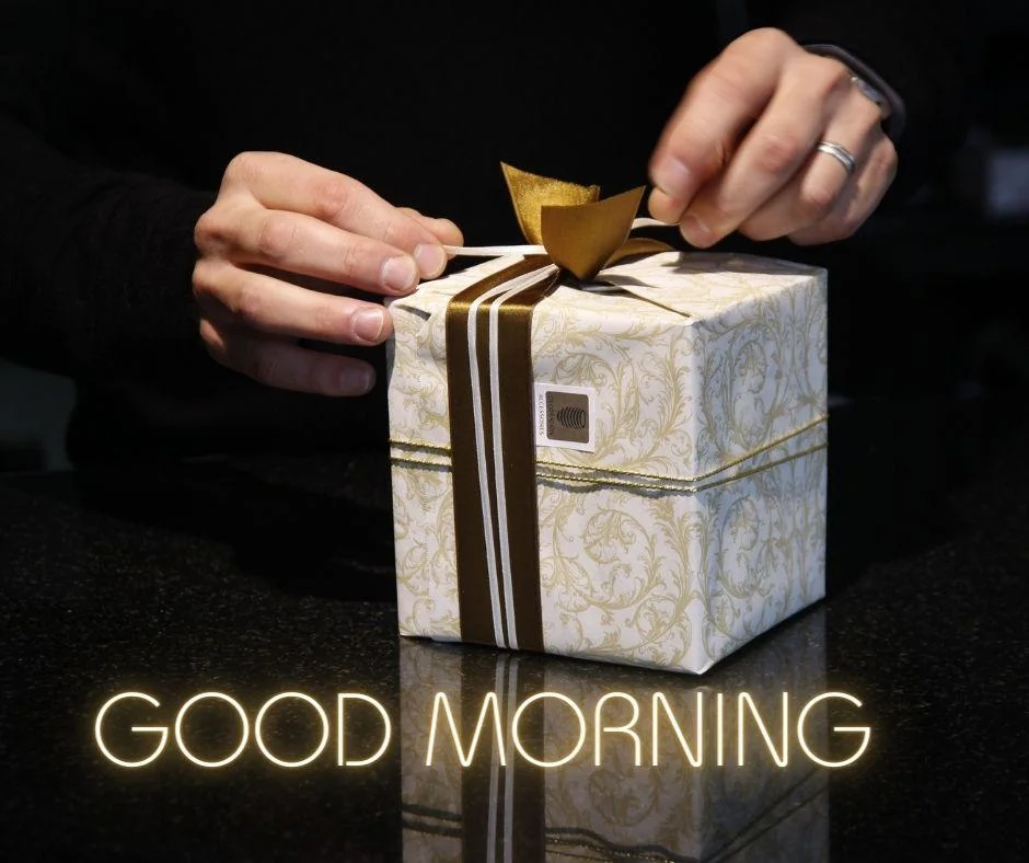 Dark black colour background with breautiful white paper on the box the hand open the box with golden colour good morning images image