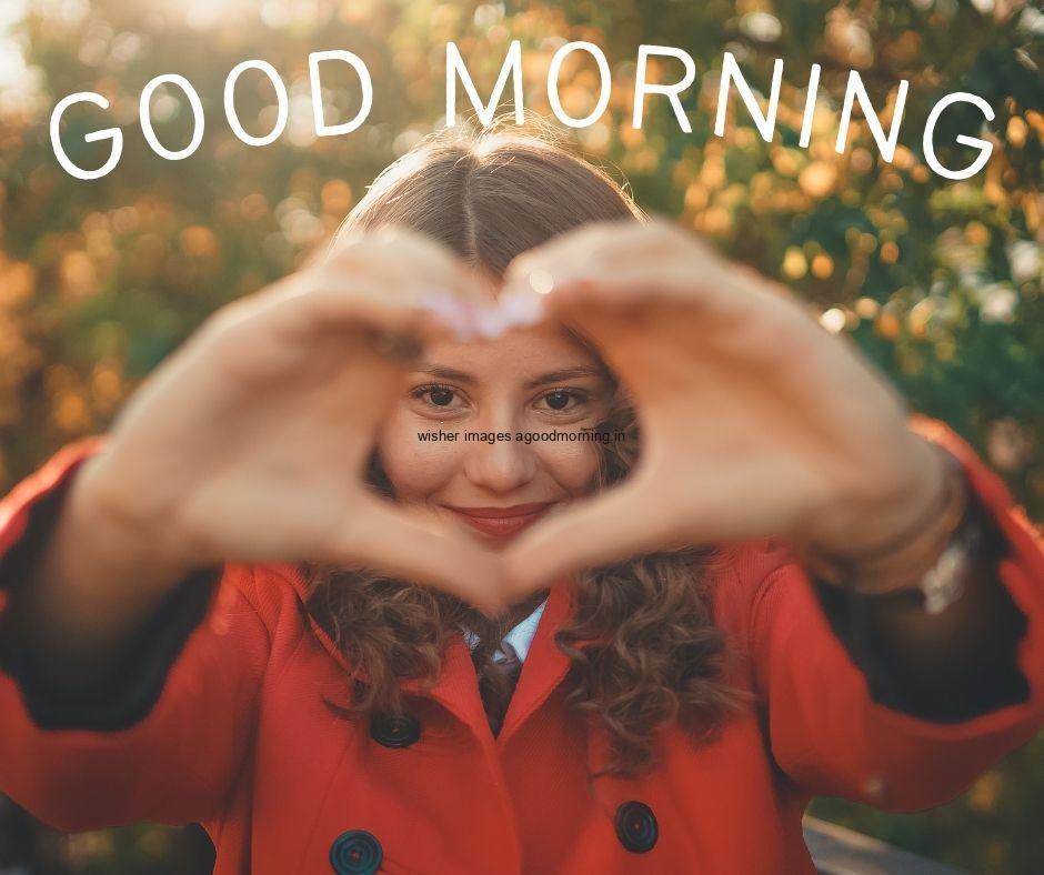 60+ HD Good Morning Love images Free 7 Girl create the heart with hand and showing the face good morning text on the top