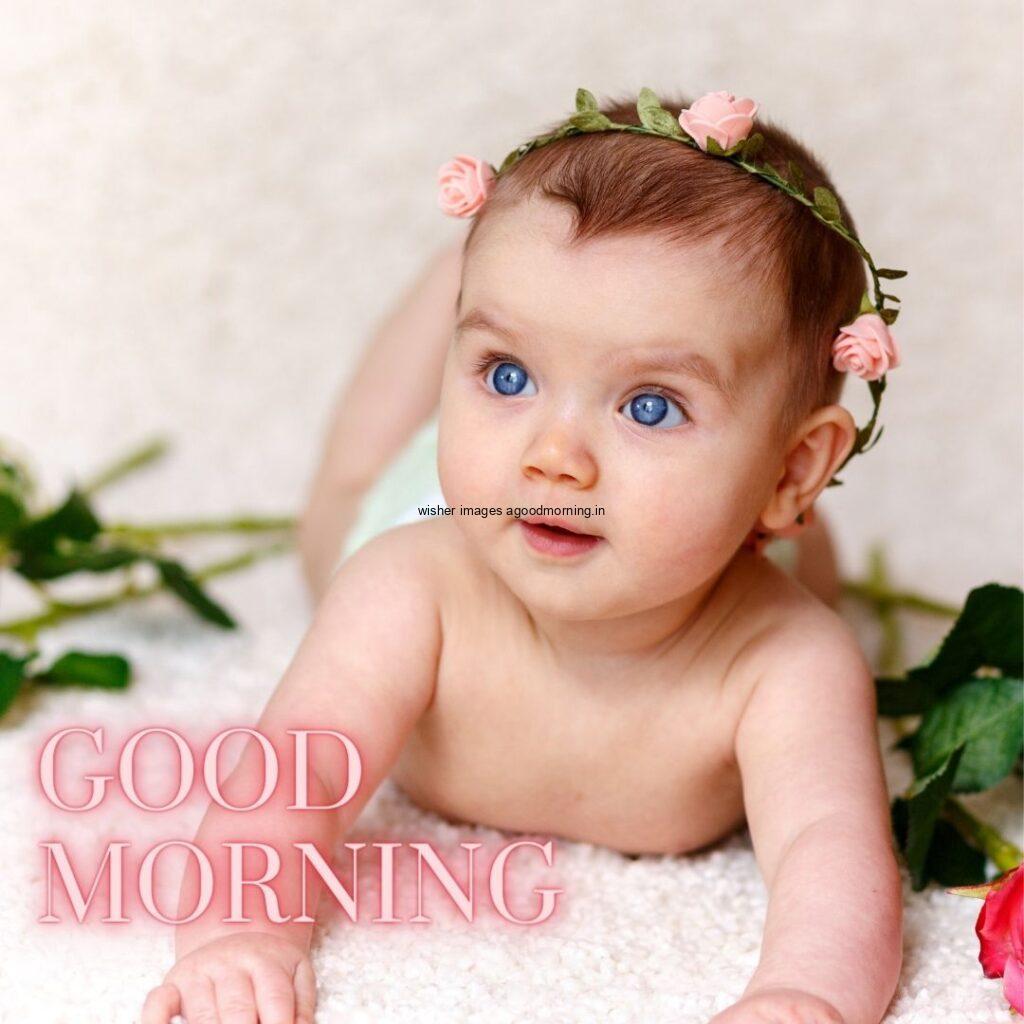 Good morning quote is placed, baby girl sitting in white mat beside the leaf is placed