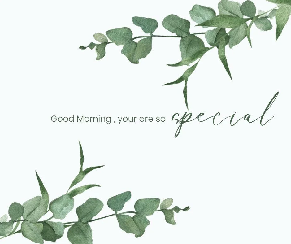 Green leafs with flowers white background good morning quote is placed