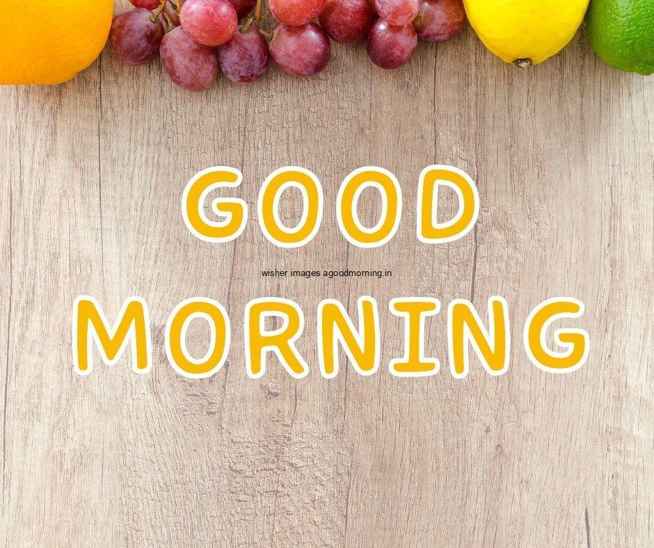 Grey background with orange fruit, strawberry good morning image text colour yellow with white border