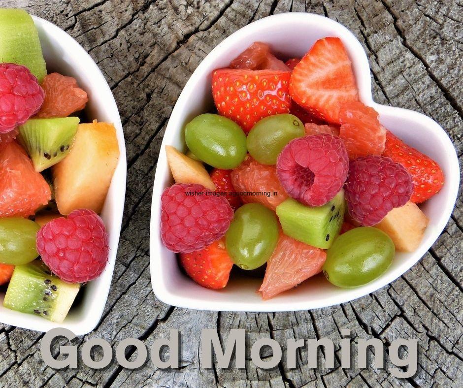 Grey background with orange, yellow fruit in bowl good morning image text colour grey with white border