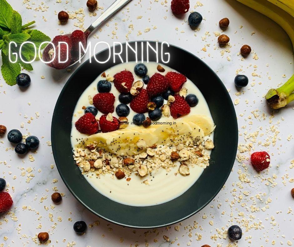 Grey background with strawberry, blue berry in bowl with milk good morning image text colour white with white border