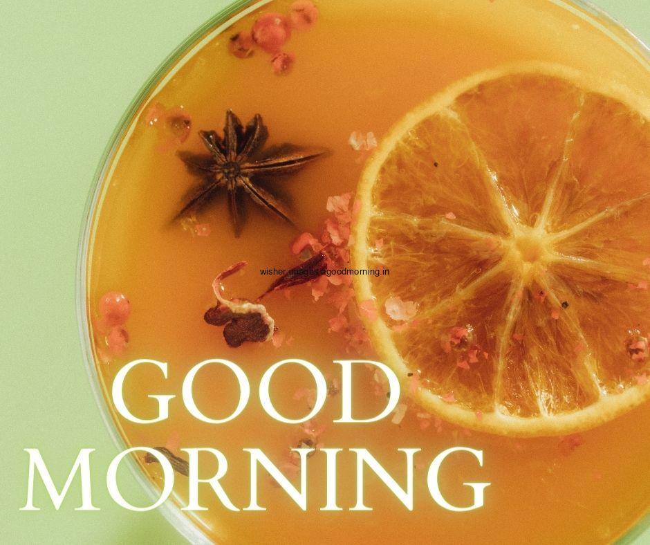 Light green background with orange half cut is visible with star spices good morning image text colour white with white border