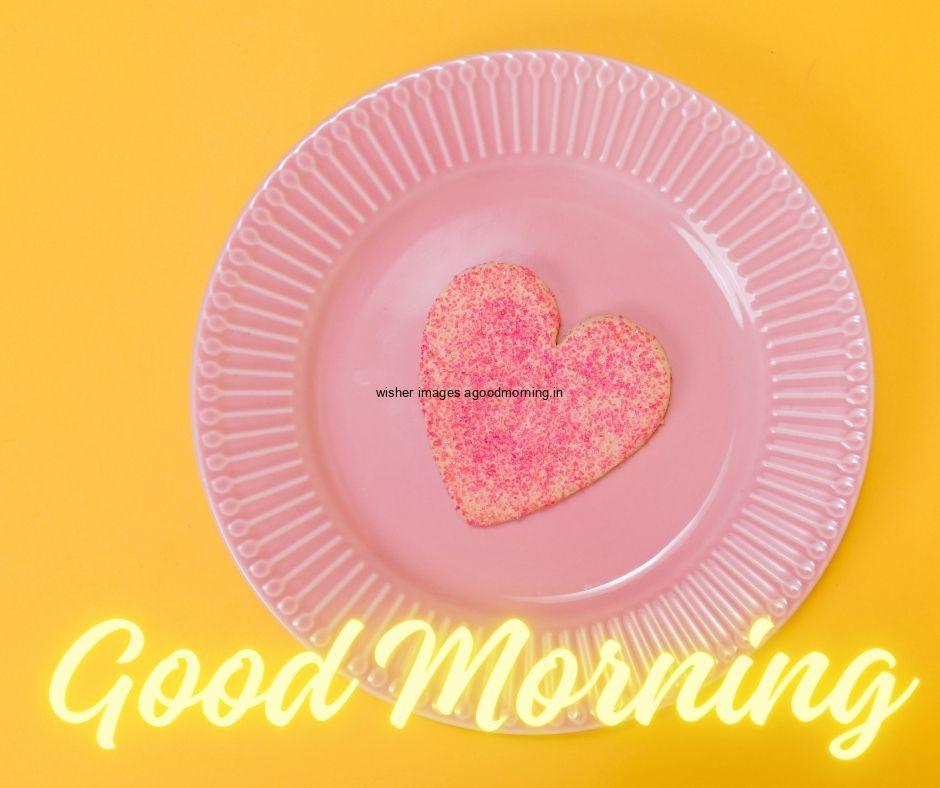 Pink heart in the pink plate in middle with light yellow background good morning love images free download