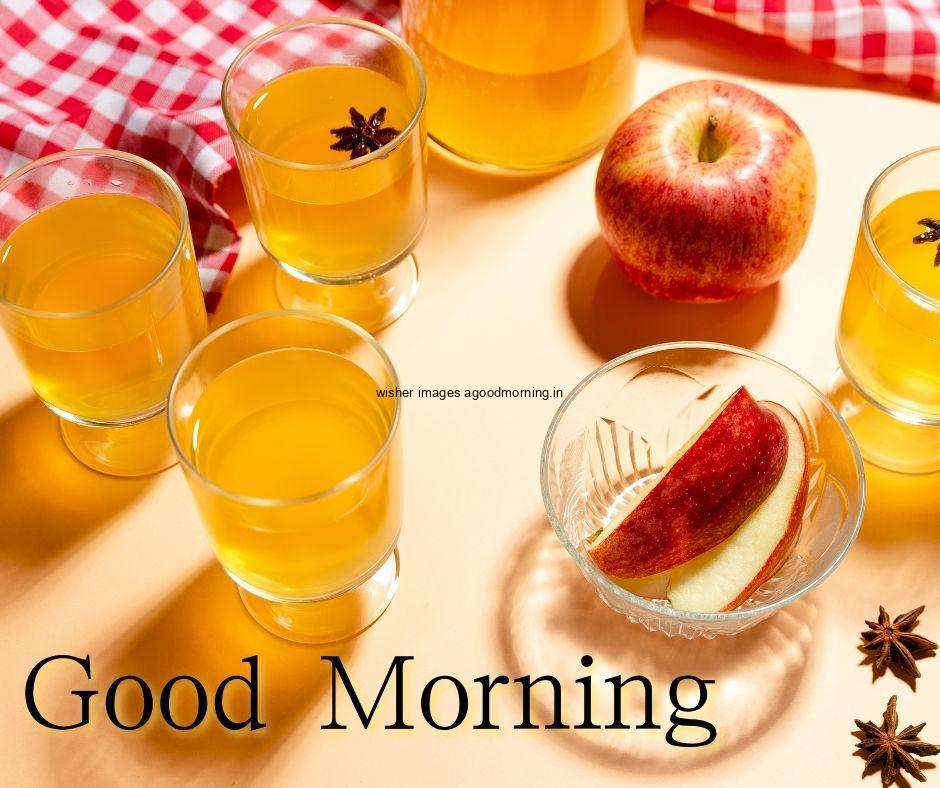 Red-Apple-with-white-patten-clothes-background-with-many-juice-glasses-white-good-morning-text-good-morning-image HD Good Morning Images with juices Free