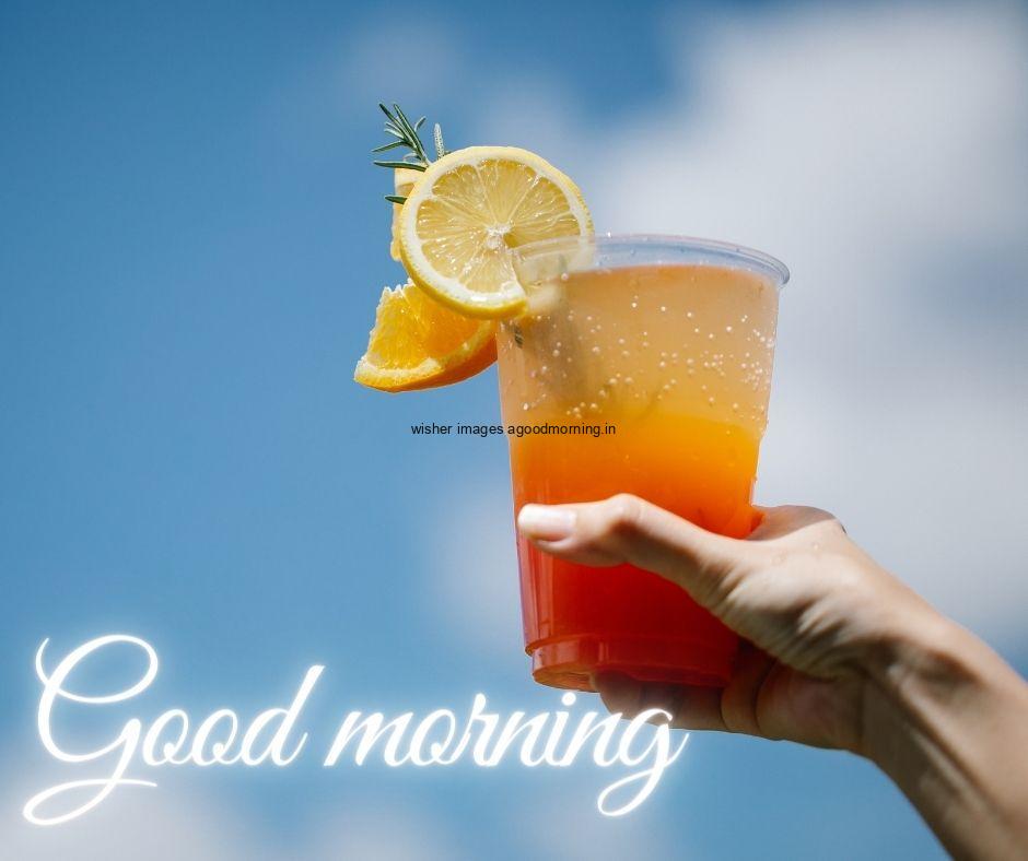 Sky-blue-background-the-hand-hold-the-juice-with-white-text-good-morning-image HD Good Morning Images with juices Free