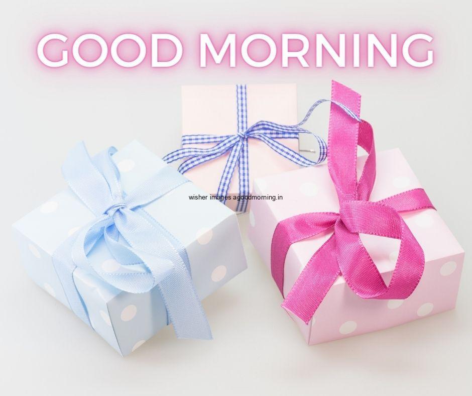 White colour background with breautiful white colour gift boxes with pink,blue and purple ribbons are placed good morning images box