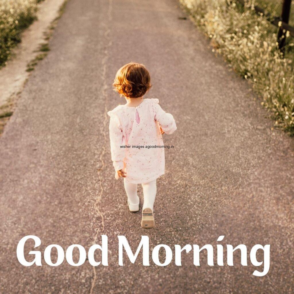 Baby girl walking on the road good morning quote is placed