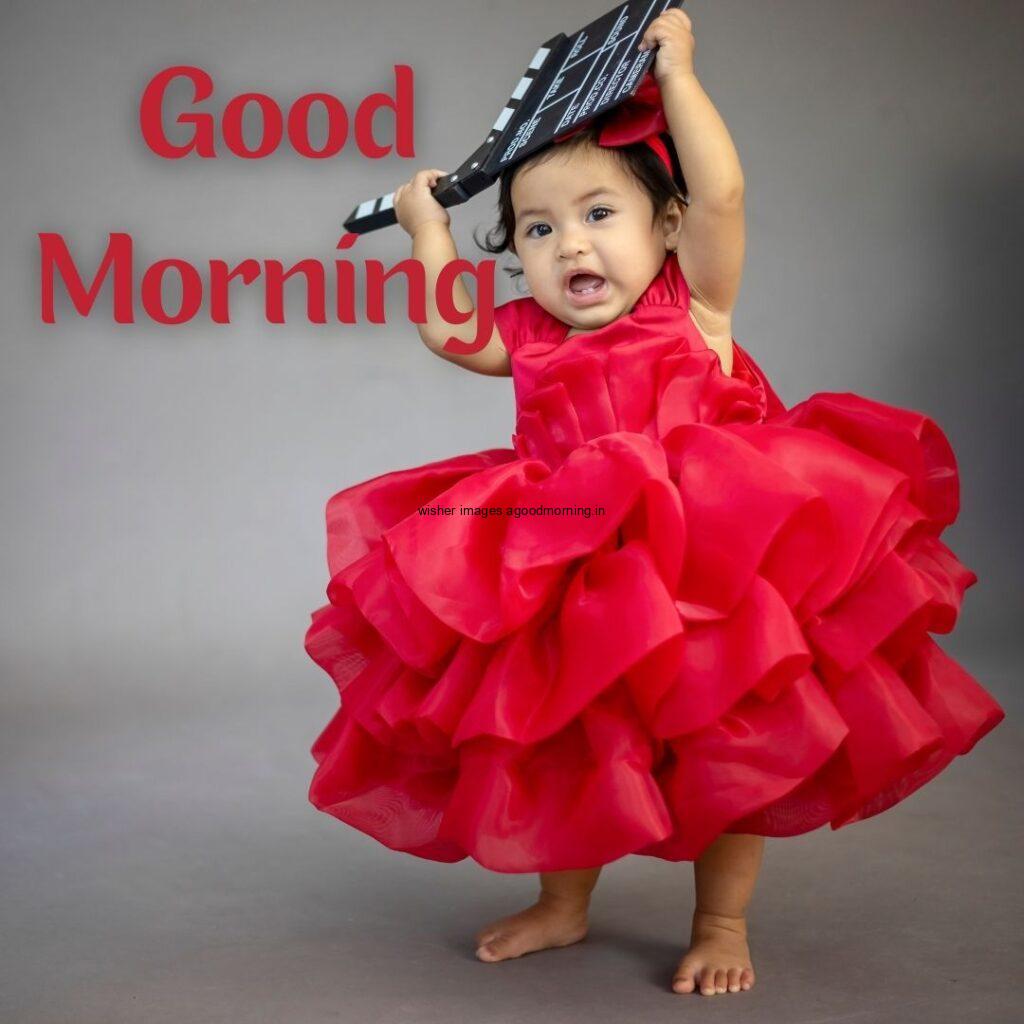 Baby girl waring the red dress, grey background is set, good morning quote is placed