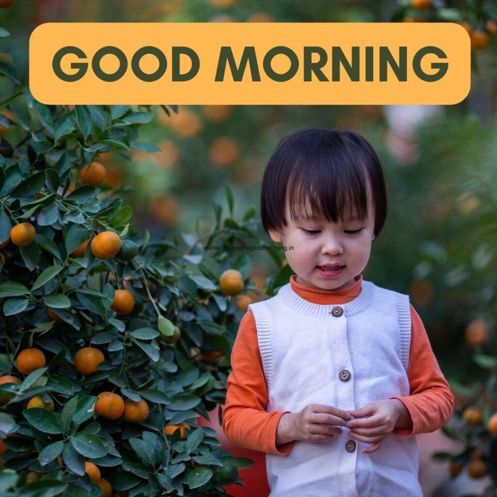 Baby waring the white with orange dress good morning quote is placed