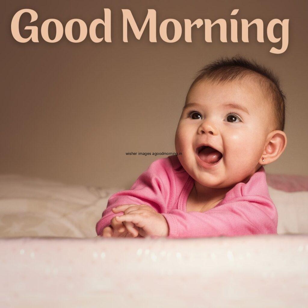 Baby wearing the pink t-shirt and brown on background is setup good morning quote is placed