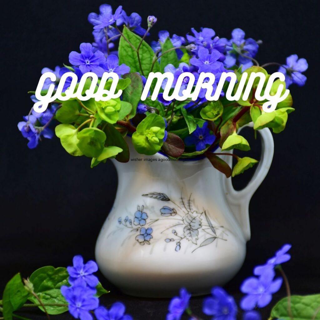 Blue flowers on the jar with green background good morning quote is placed with white colour