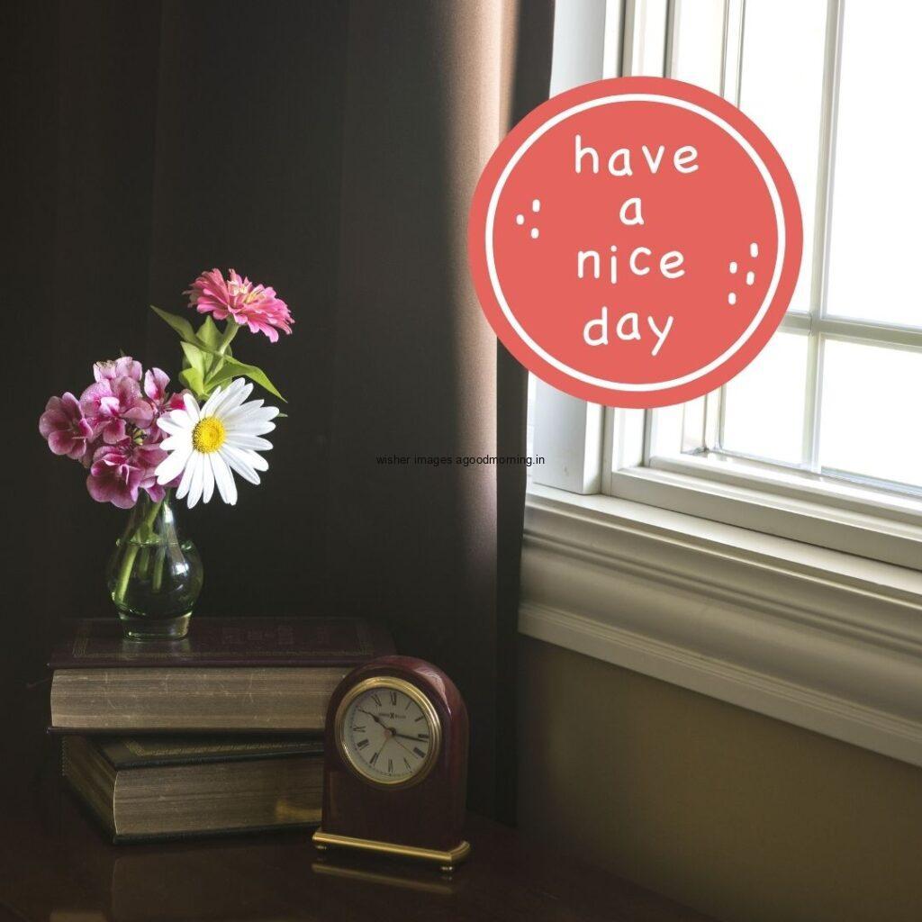 Flowers is on the book beside the clock is placed good morning quote is placed