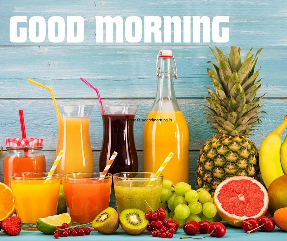 fruits with jucie with sky blue background with good morning text good morning image half cutting fruit