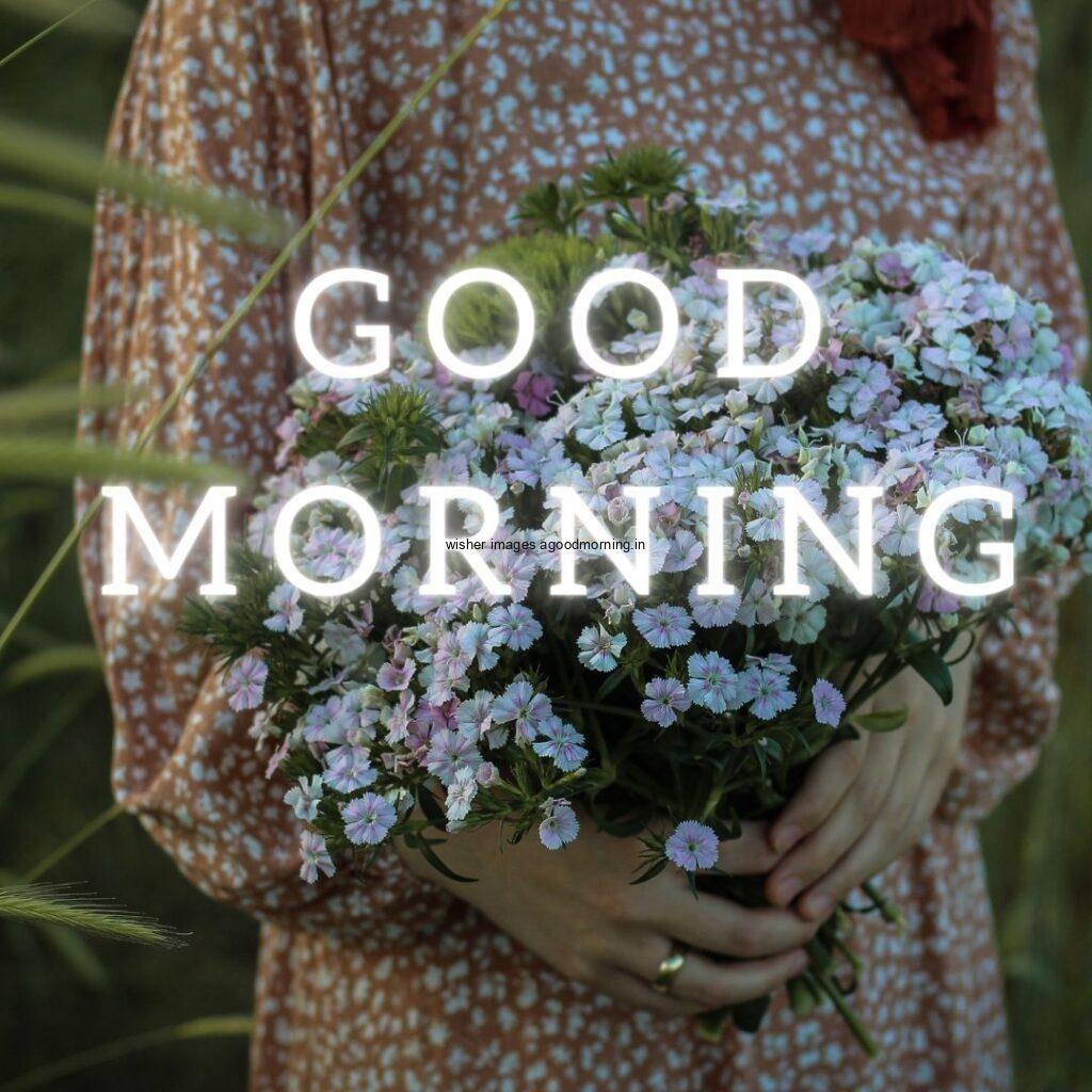 Girl holding the little flowers good morning quote is placed