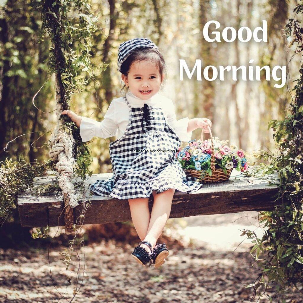 Good morning quote is placed, the baby wearing the dress behind the forest background is setup