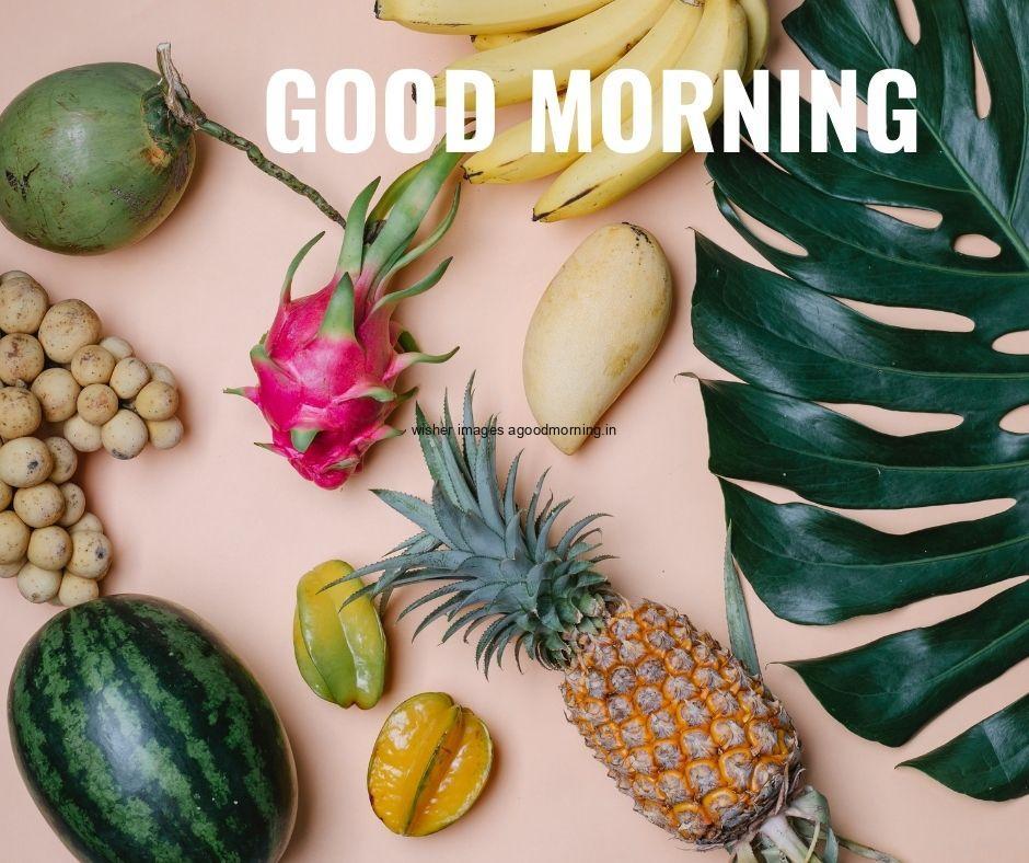 Grey background with watermelon pineapple, dragon fruit placed good morning image text colour white