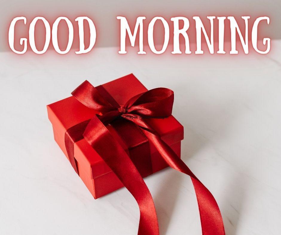 grey with white colour background with breautiful red gift box with red ribbon good morning images box