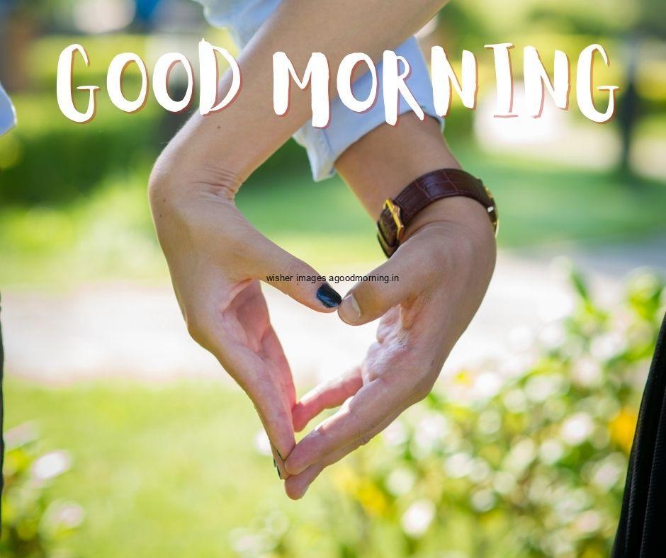 Hand create the heart with good morning quote is placed colouful blue background