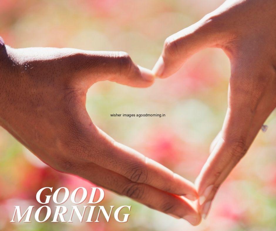 Hand create the heart with good morning quote is placed colouful blue background