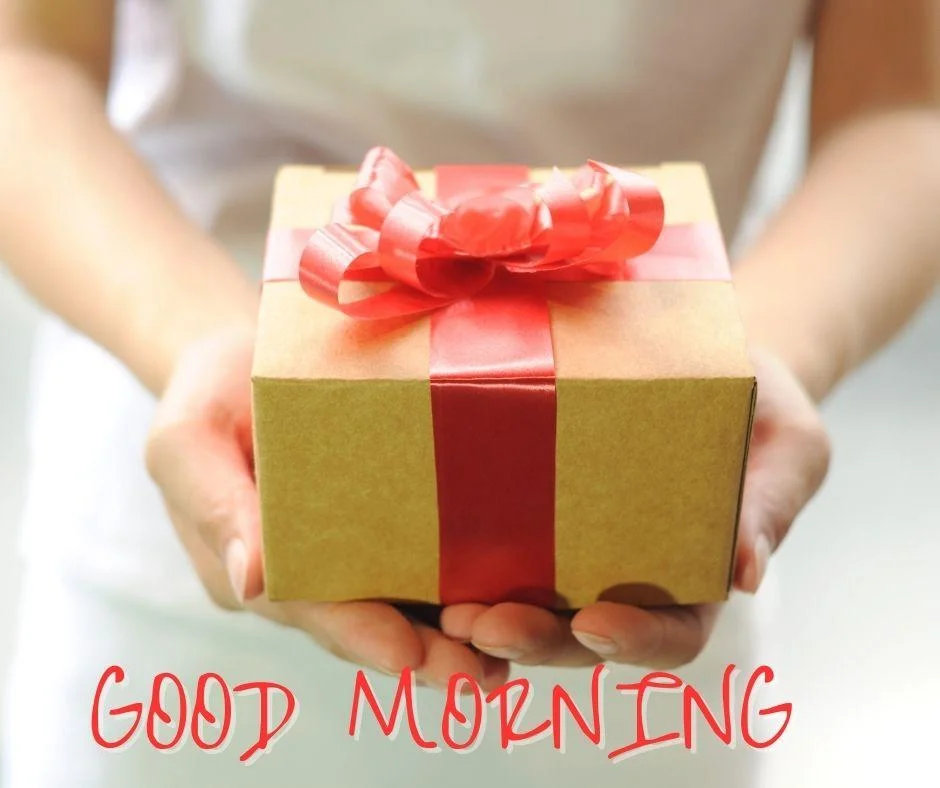 lady hold the yellow colour gift with red ribbon box good morning images box