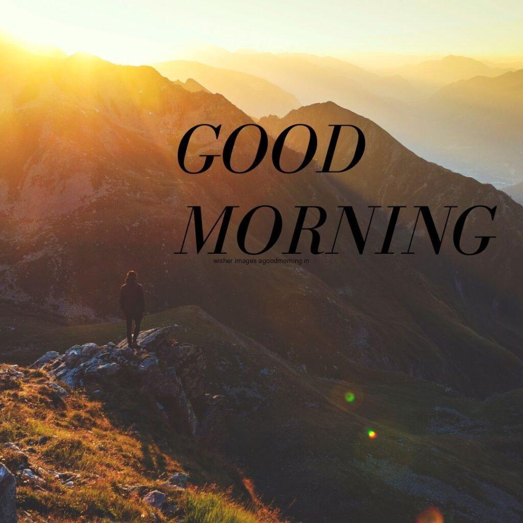 Mountain with sun light good morning quote is placed