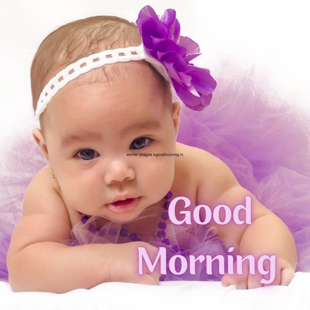 Purple frock is wearing baby good morning quote is placed white background is setup