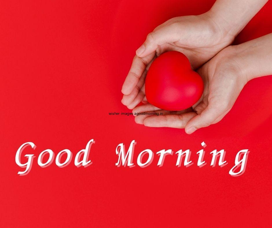 Red background with hand holding the heart good morning images