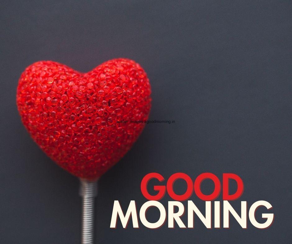 Red heart on the stick good morning quote is placed with white and red