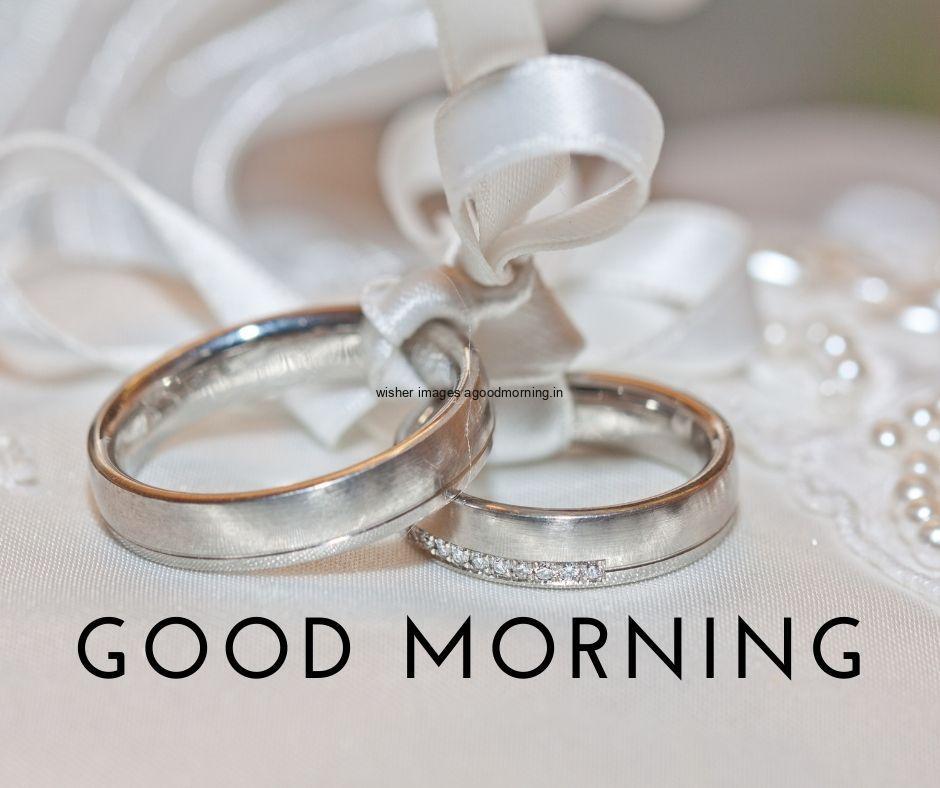 Rings with ribbon grey background good morning quote is placed text colour is black