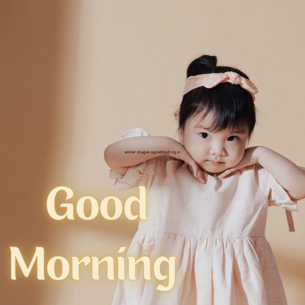 Smile baby pink dress is wearing good morning quote is placed