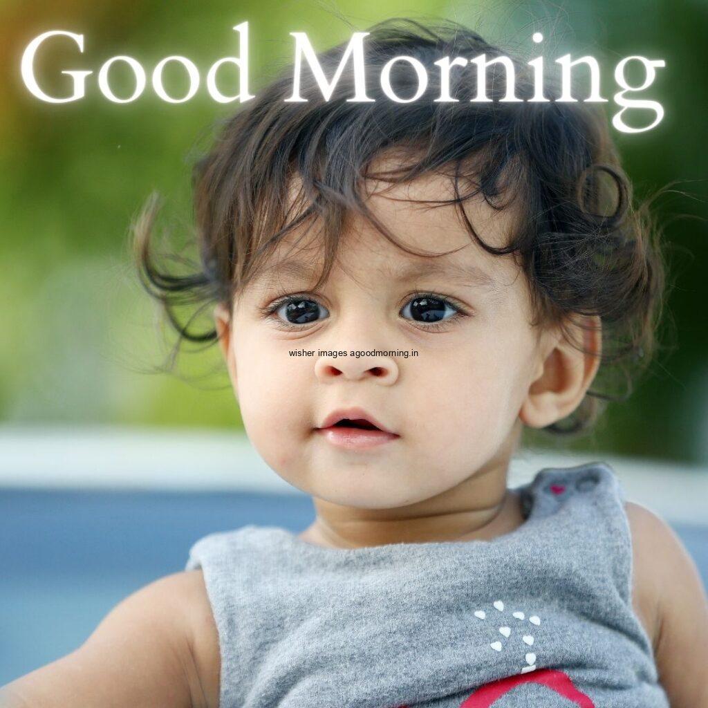 Smile baby seen in front and pink dress is wearing good morning quote is placed