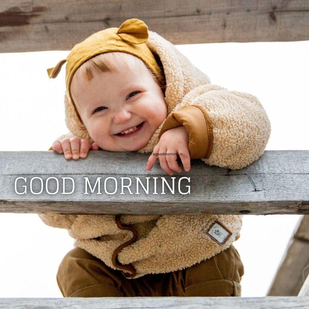 Smile baby is hanging on the wood, good morning quote is placed