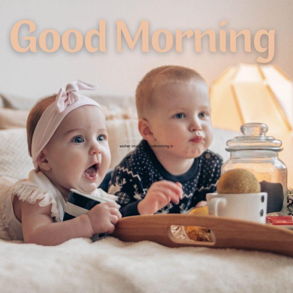 Two baby sitting together and eating the food, good morning quote is placed