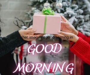 two hand holding the gift box with green ribbon good morning image