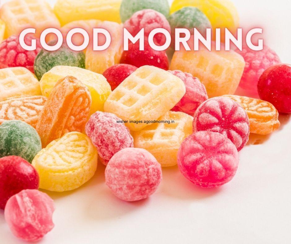 white background with candy placed in middle good morning image text colour green with white border