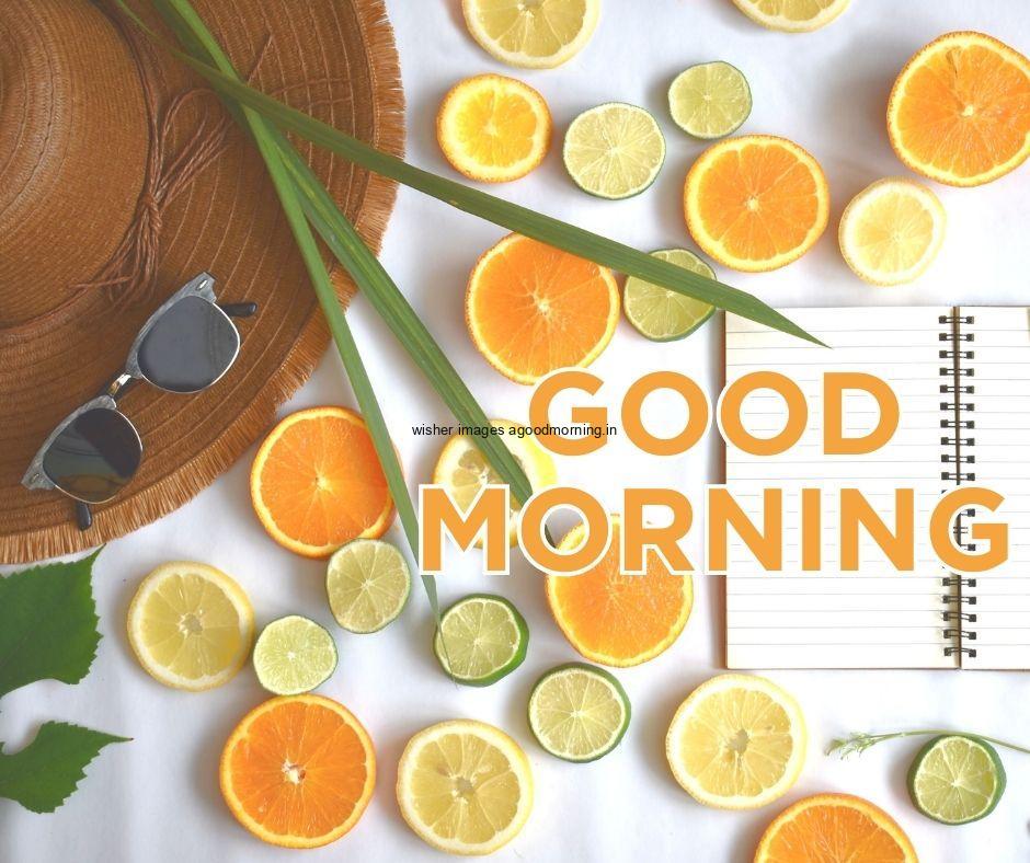 white background with orange with lemon cut open book is placed good morning image text colour white with white border