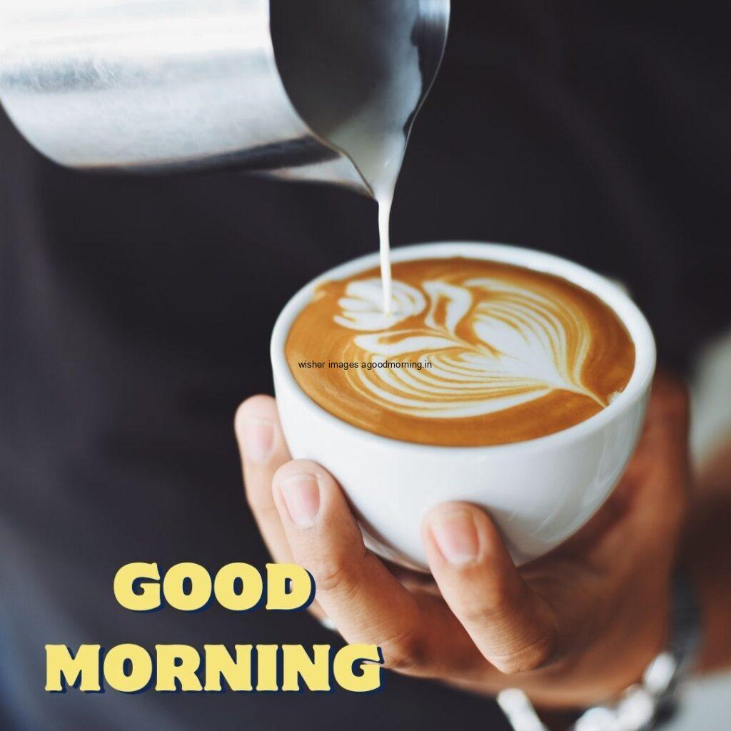 Hand create the heart in the coffee cup with dark background good morning image