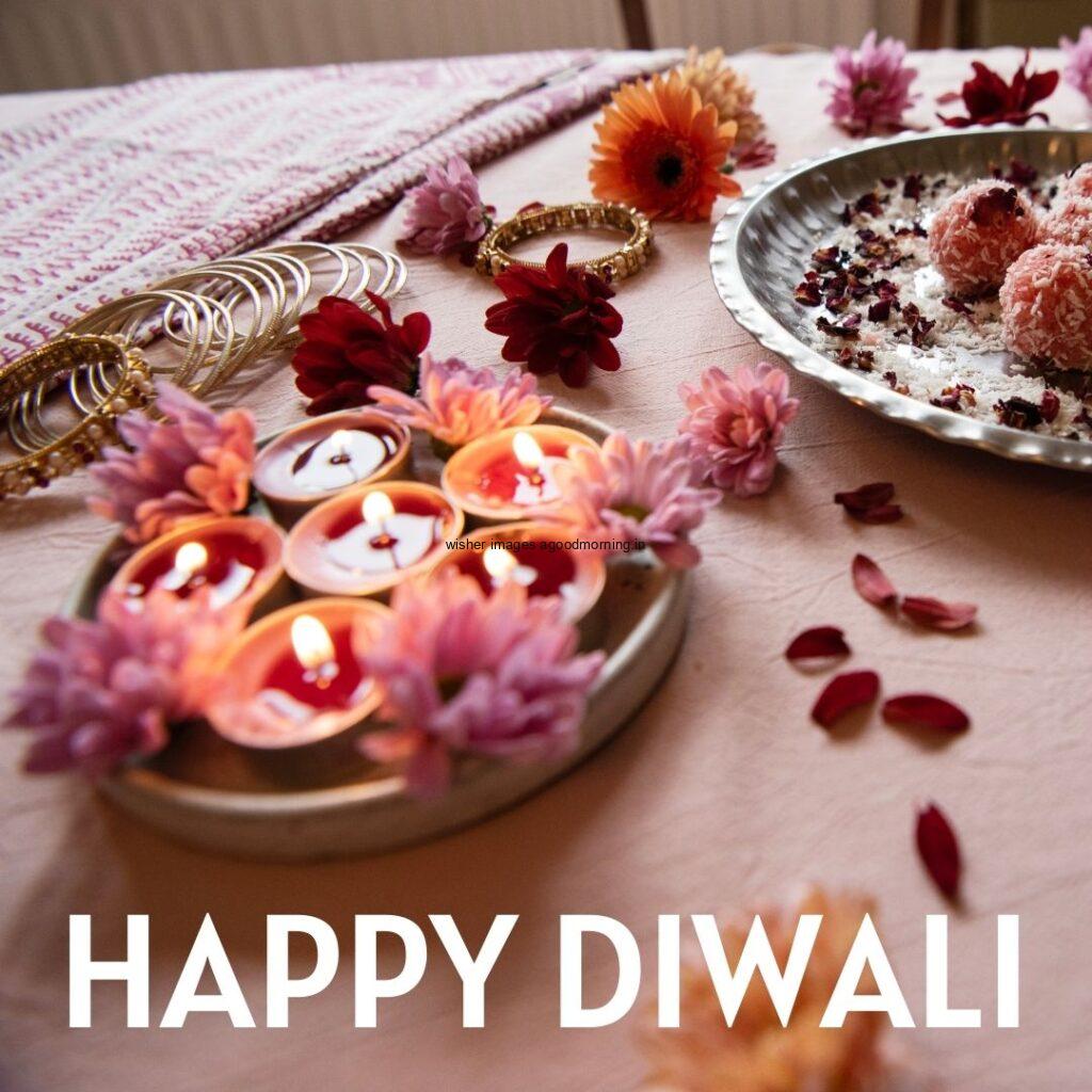 beautiful background flowers on the plate beside the diya is placed with happy diwali image