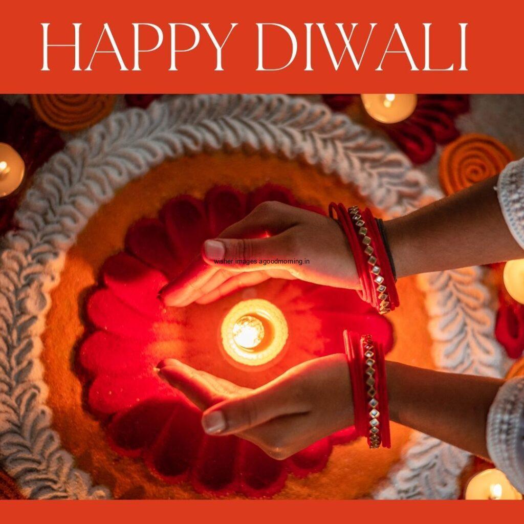 beautiful rangloi makes combo with red & white many diya & flowers placed hand close on the diya happy diwali image