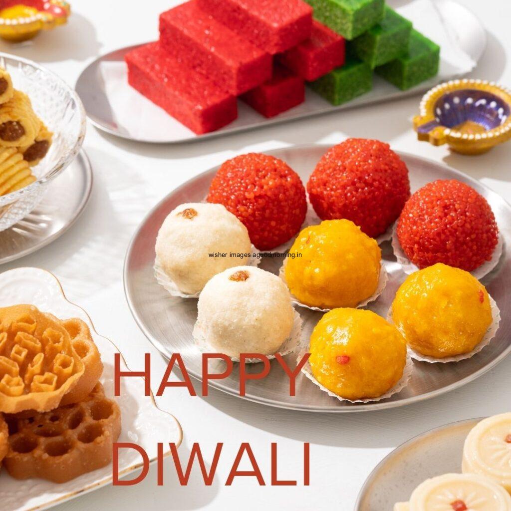 colourful laddu with many sweets white background with happy diwali image